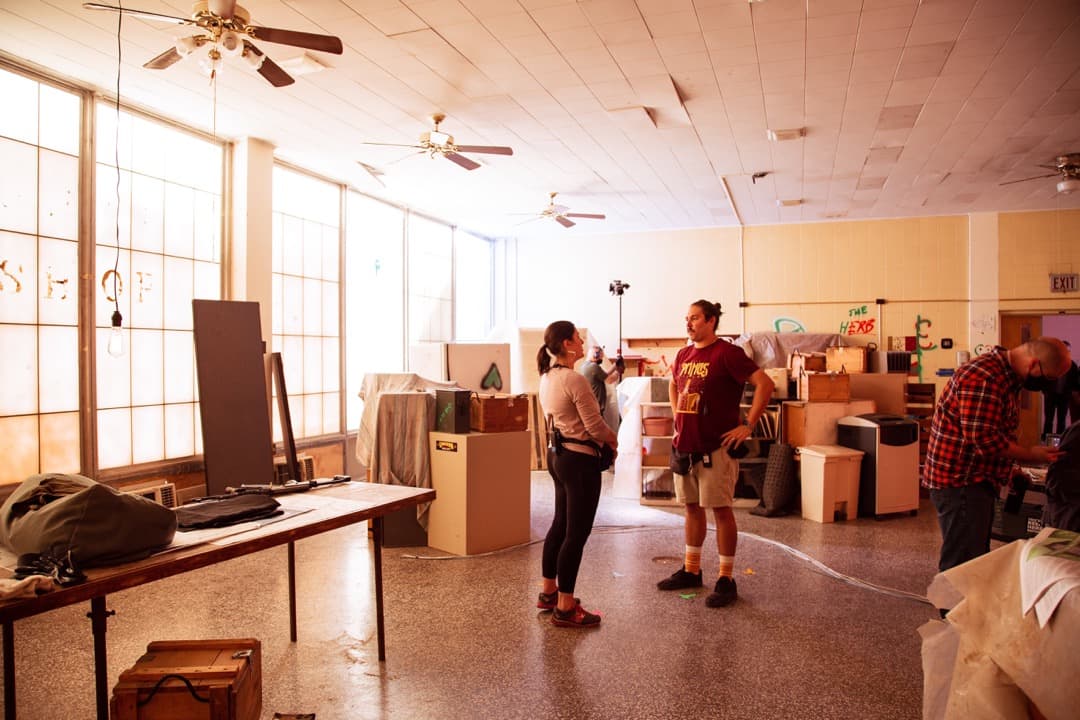 Behind the scenes photo 62 from Clone Cops production showing key pa jenny gill and 2nd 2nd ad woody dunne prepare for a scene